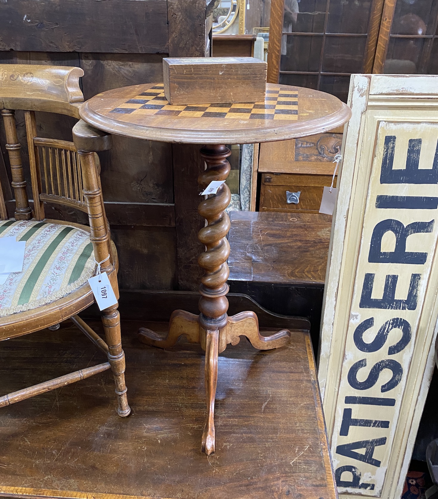 A Victorian inlaid walnut circular tripod games table, diameter 49cm, height 69cm together with a box wood chess set